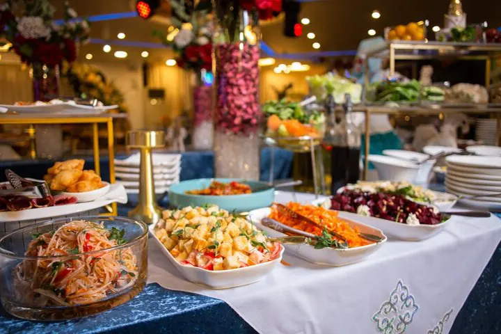Beautifully arranged gourmet salad and appetizers with fresh ingredients at a high-end birthday party catered by Joyous Events