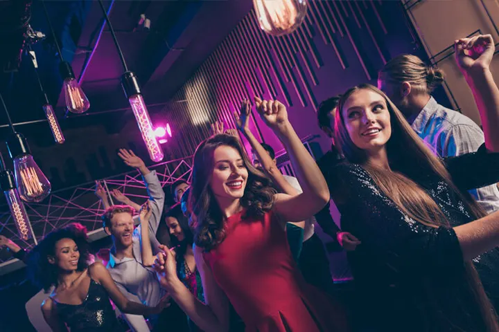 Professionals enjoying a night party with dancing and music at a corporate celebration organized by Joyous Events